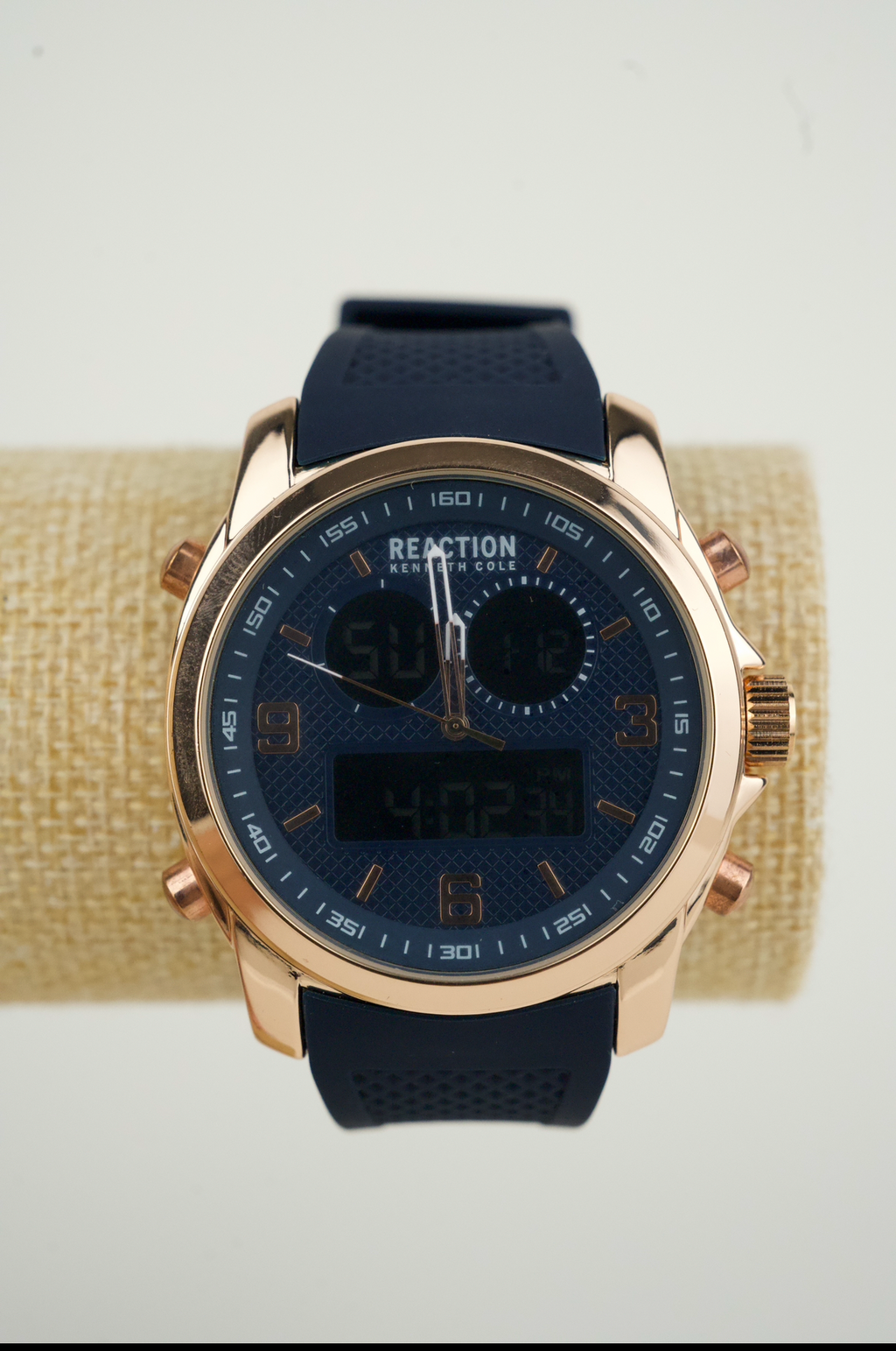 Kenneth Cole Reaction men's analog-digital watch with a rose gold-tone case and a blue silicone strap.