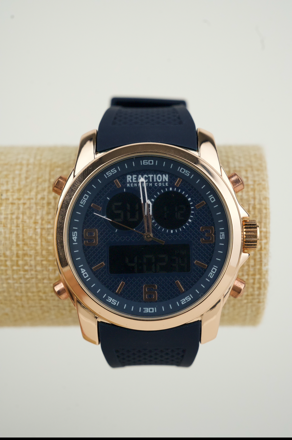 Kenneth Cole Reaction men's analog-digital watch with a rose gold-tone case and a blue silicone strap.
