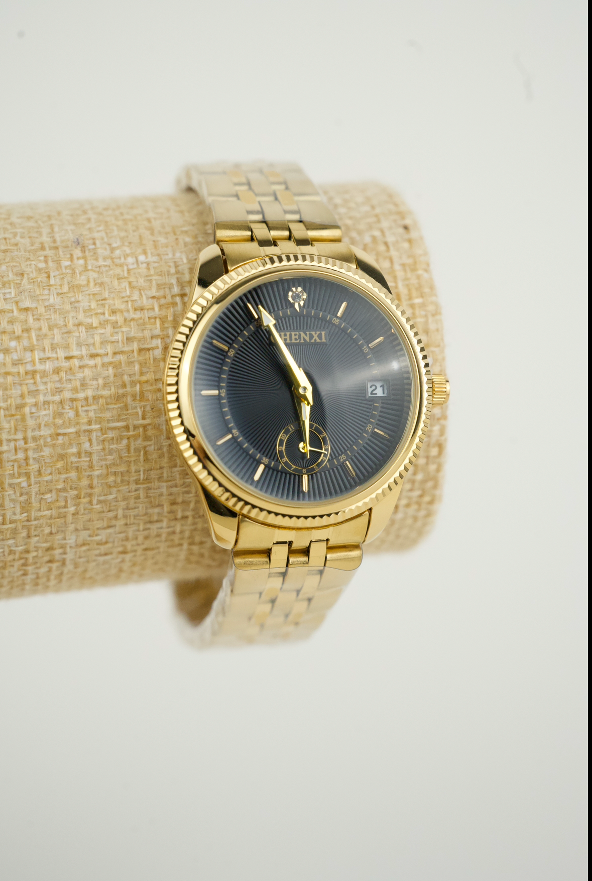 This is a gold-tone Chenxi  men's quartz watch with a black dial and date window