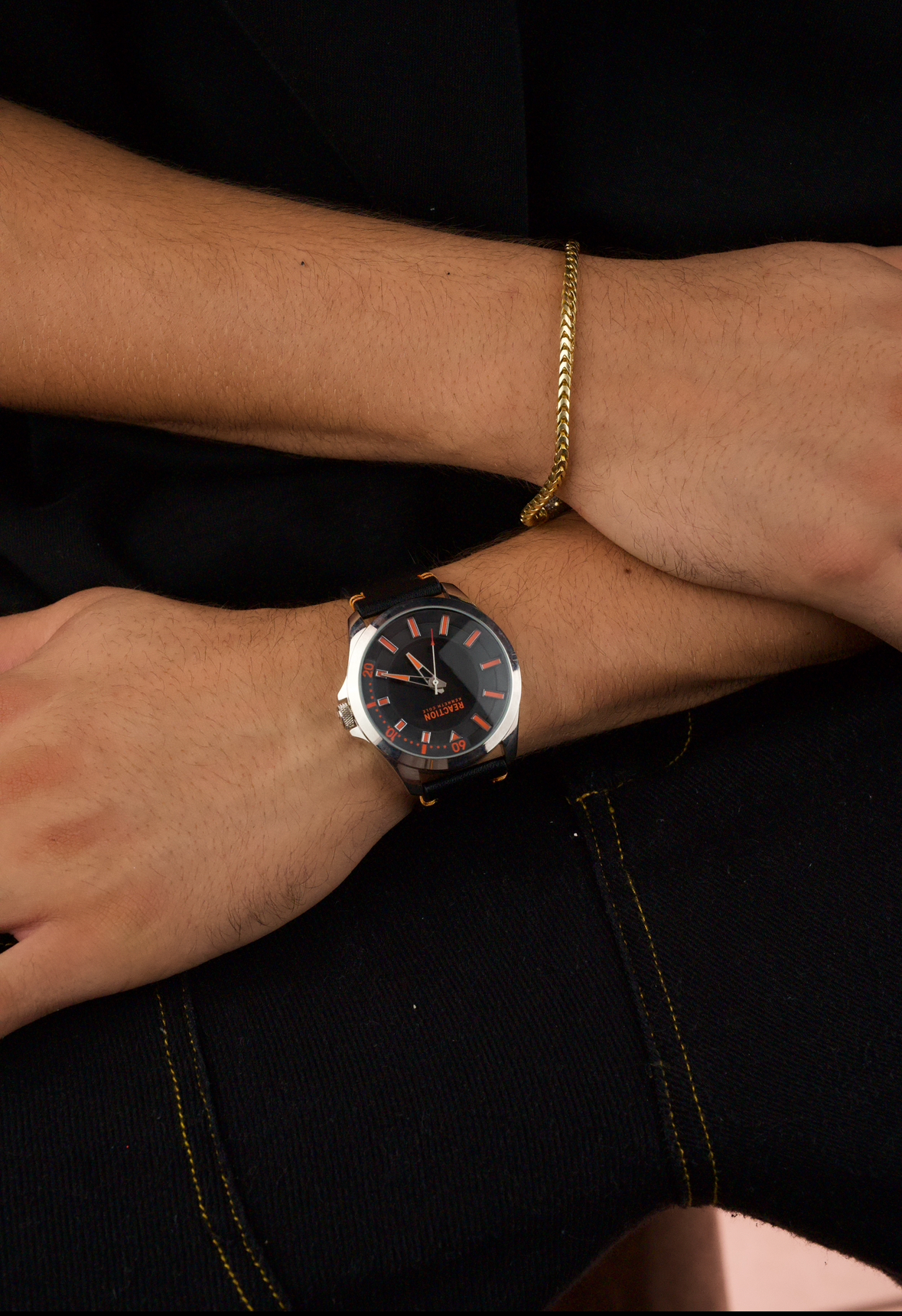 Kenneth Cole Reaction men's analog black leather strap watch with a black dial and orange accents