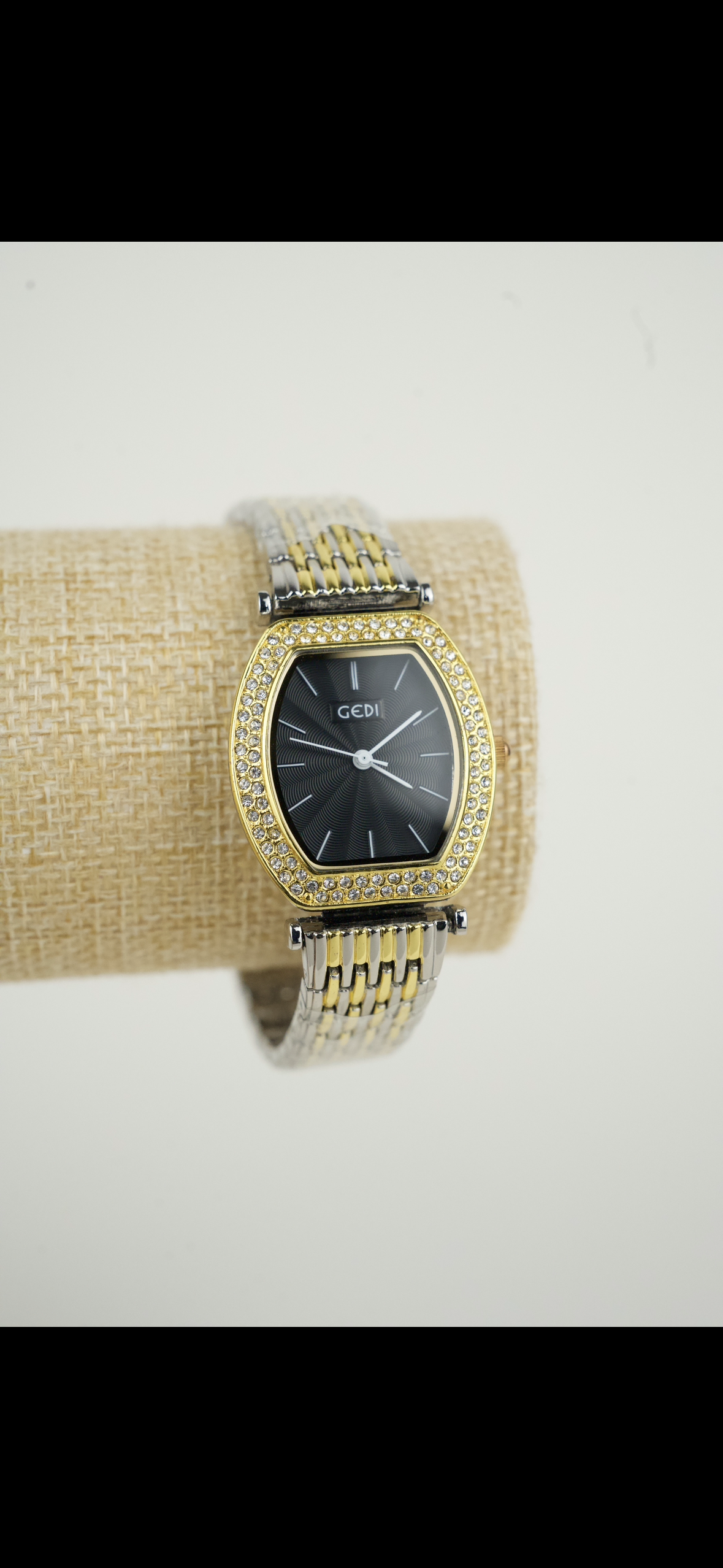 This is a GEDI women's two-tone wristwatch with a black analog dial and crystal-accented bezel