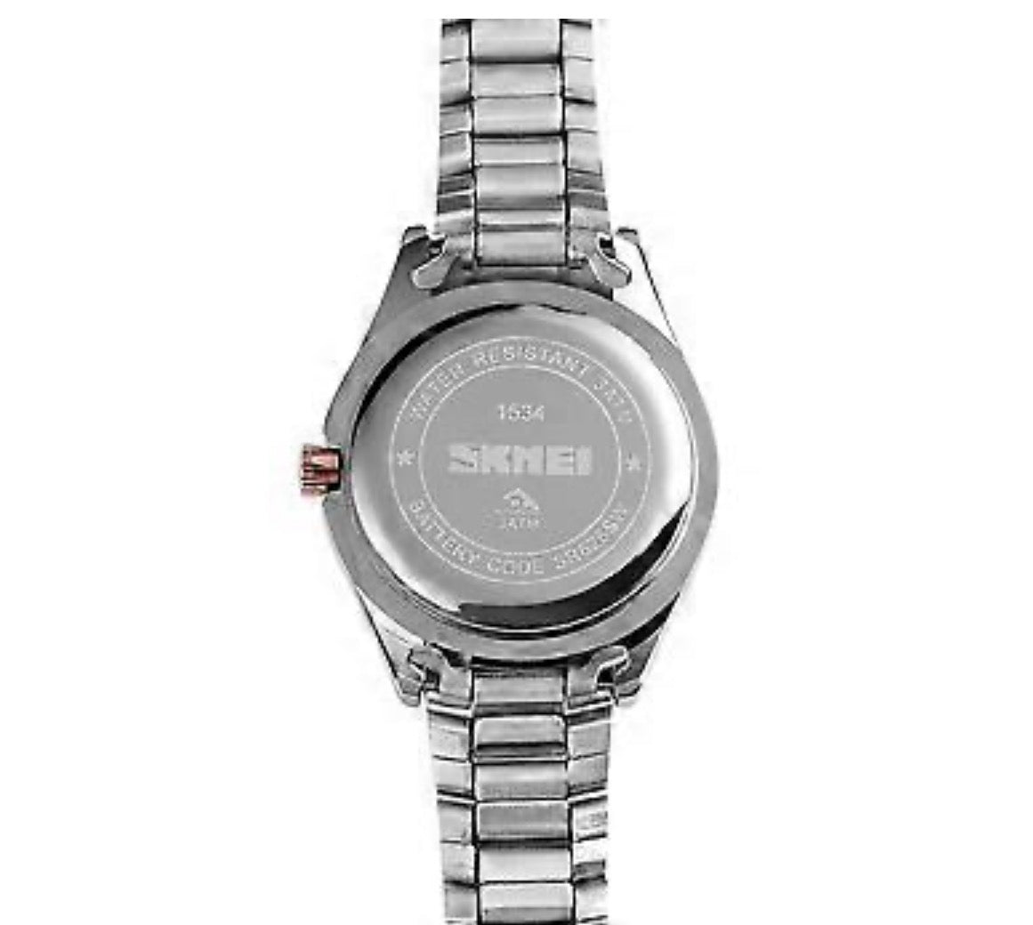 This is a SKMEI 1534 women's quartz watch with a stainless steel band and a gold-tone, rhinestone-inlaid bezel