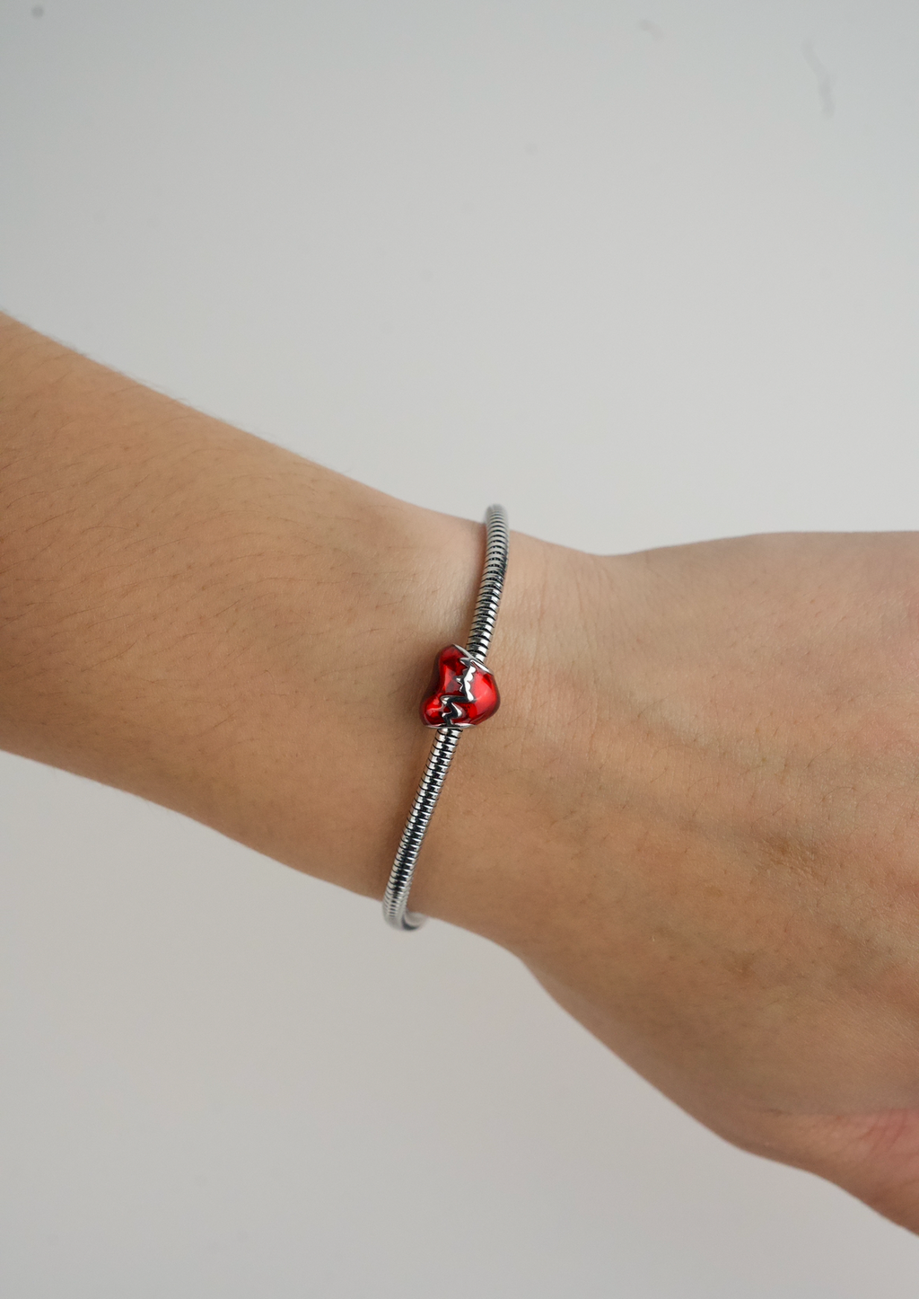 Metallic Red Heart Charm in stainless steel with hand-applied transparent red enamel.