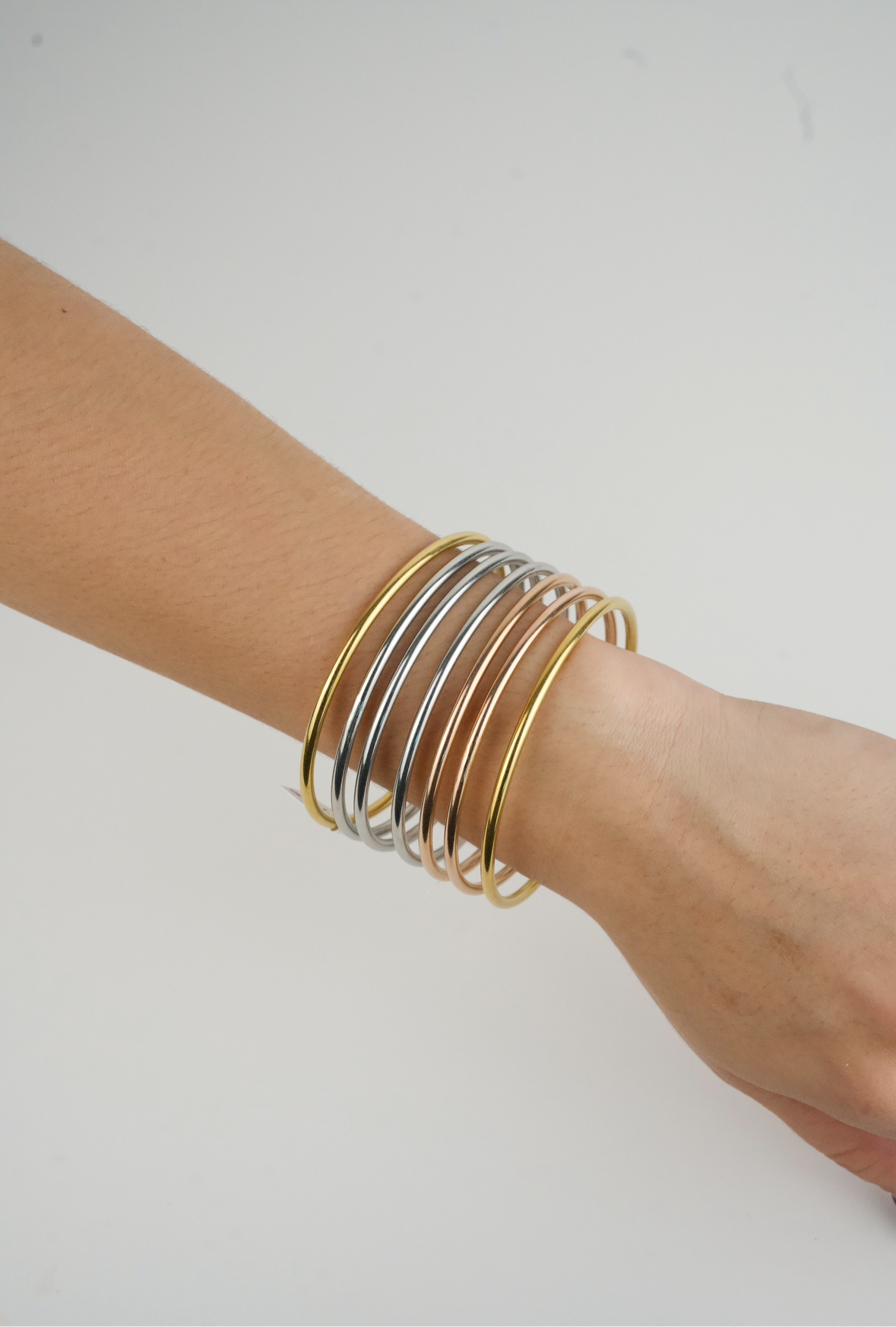 set of tri-color stainless steel bangle bracelets.