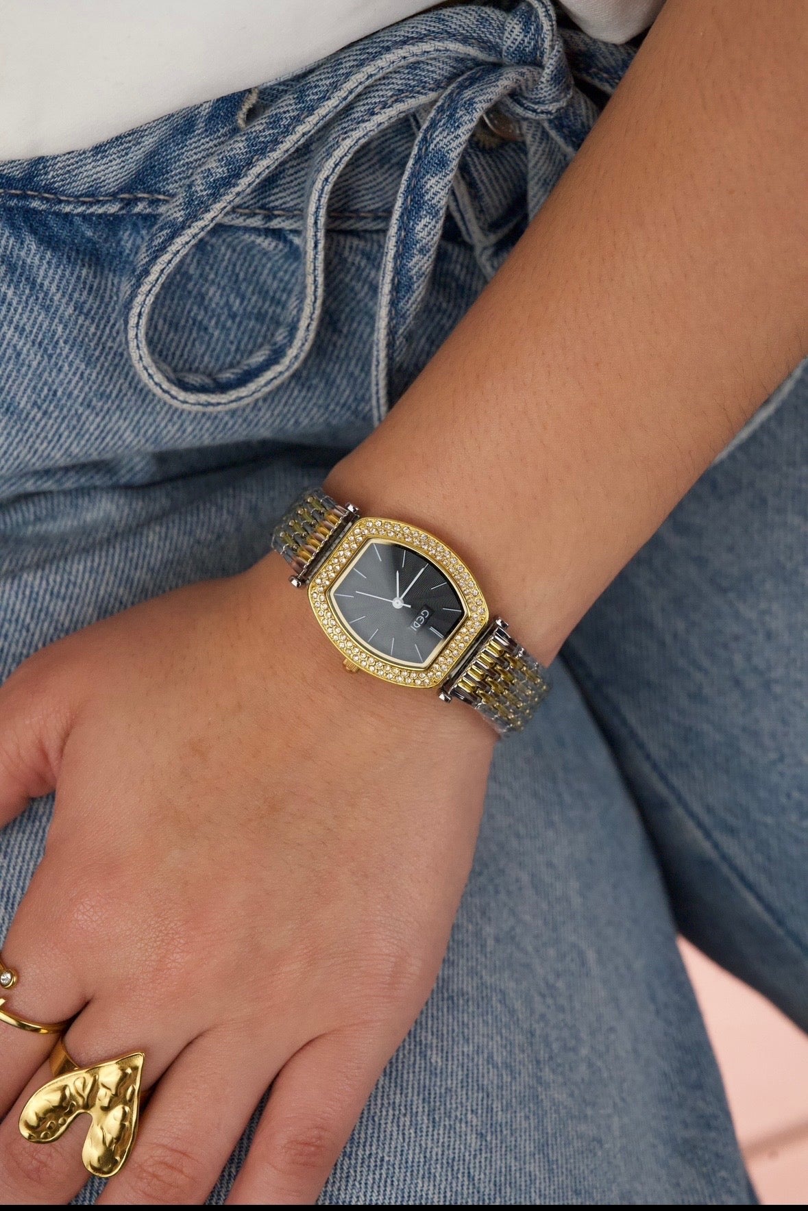 This is a GEDI women's two-tone wristwatch with a black analog dial and crystal-accented bezel