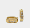 Stainless steel gold huggie hoop earrings with three channel-set diamonds or cubic zirconia in each hoop.