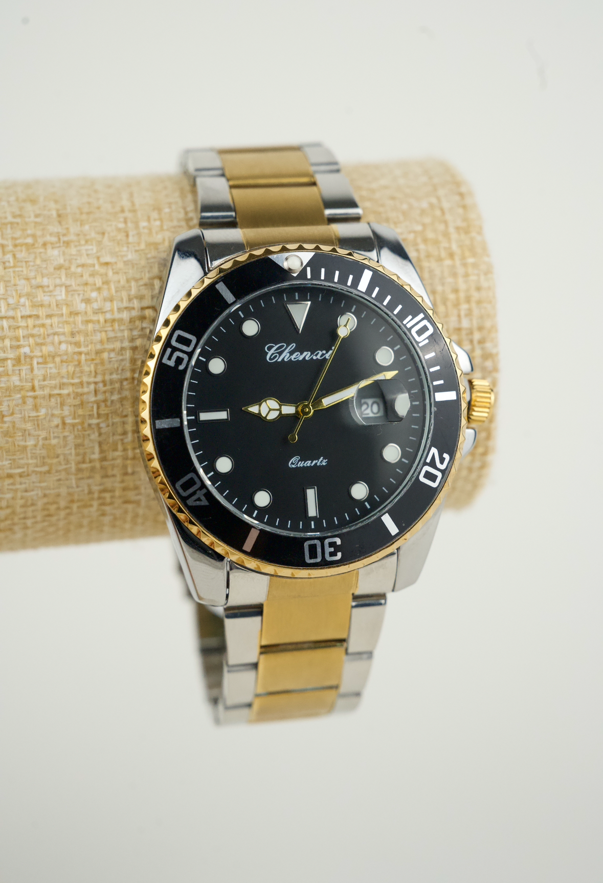 This is a Chenxi two-tone stainless steel quartz watch with a black dial and rotating bezel.