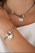 stainless steel snake chain charm bracelet with a heart clasp and a matching necklace.