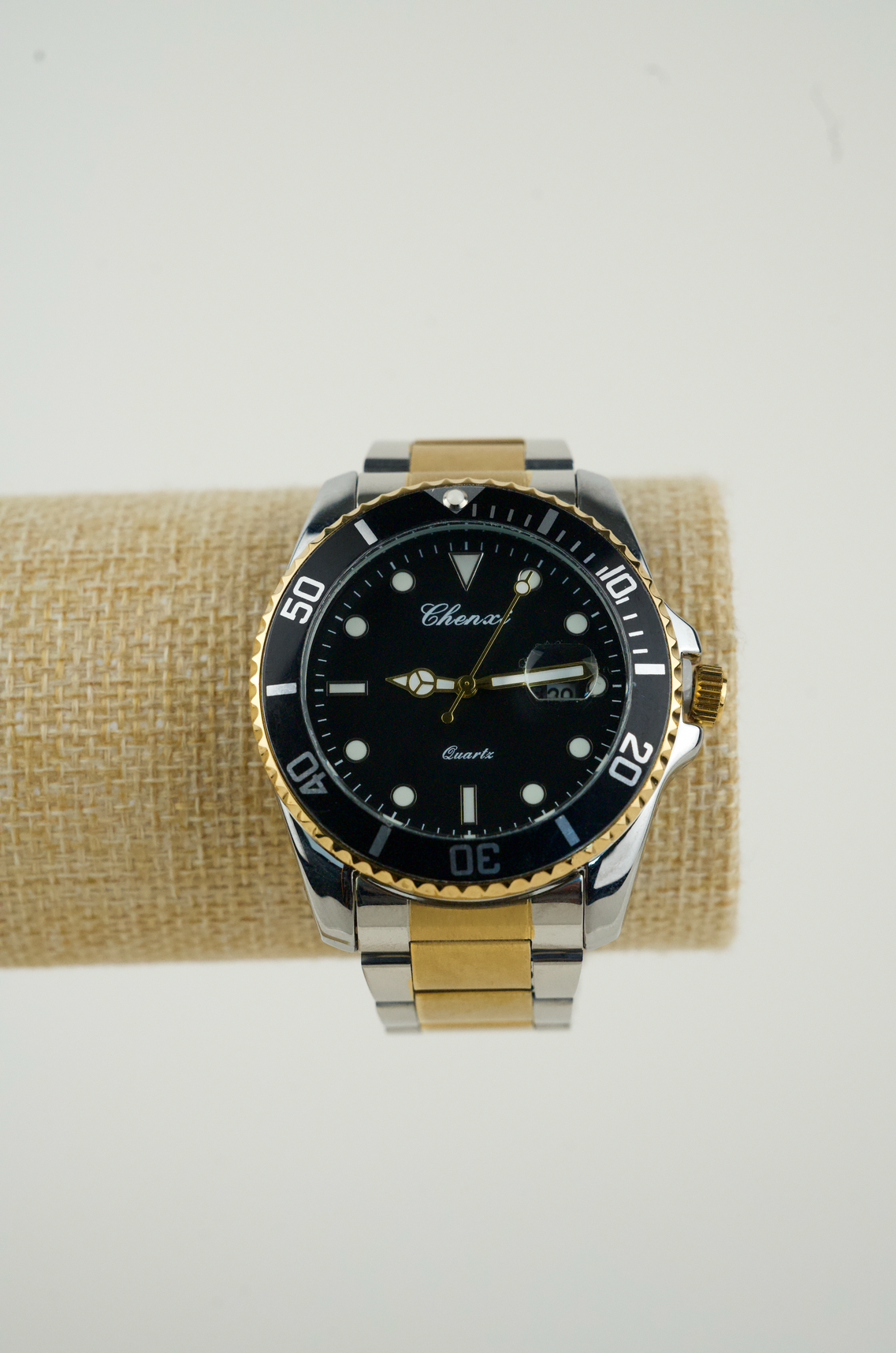 This is a Chenxi two-tone stainless steel quartz watch with a black dial and rotating bezel.