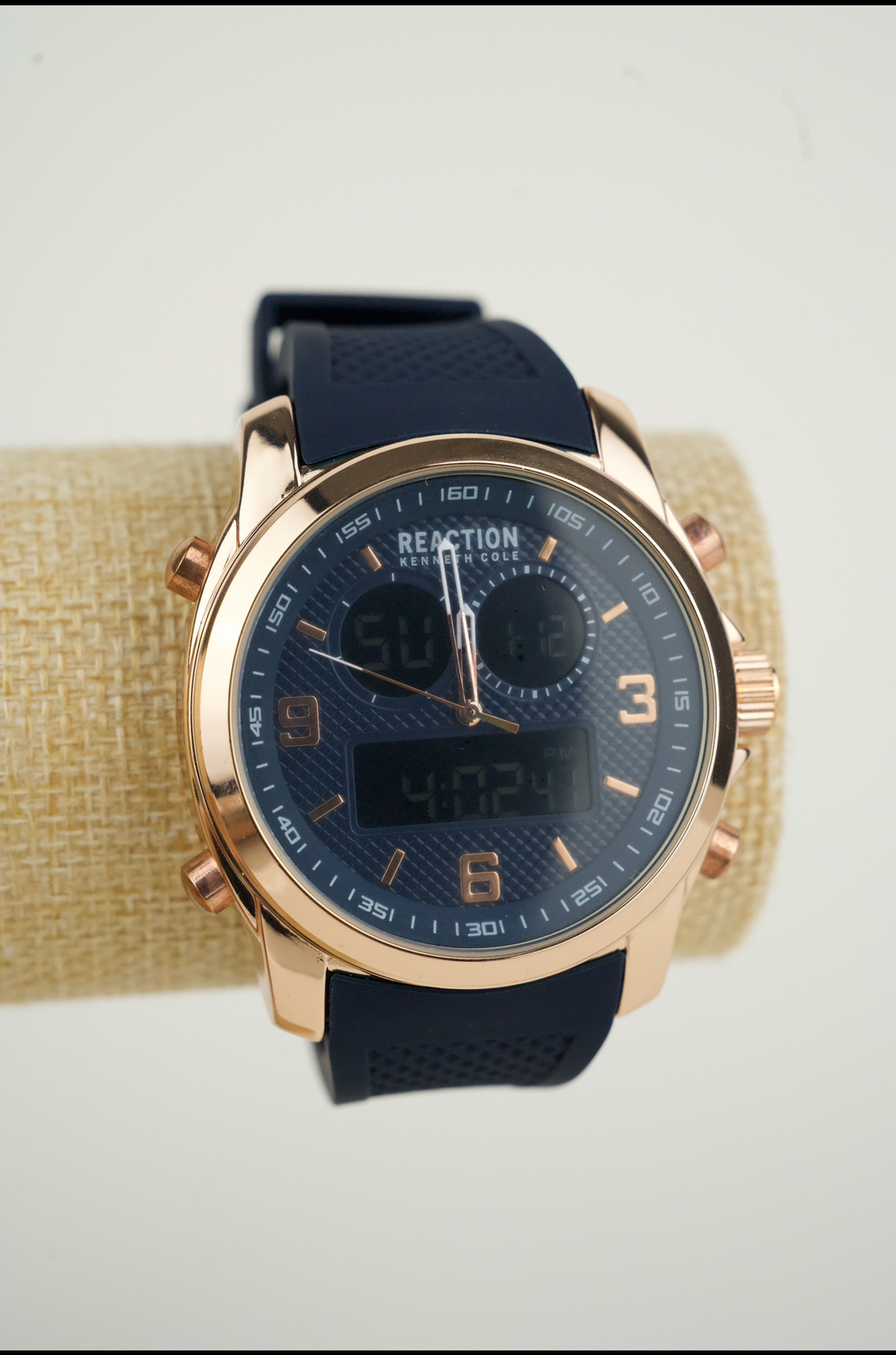 Kenneth Cole Reaction men's analog-digital watch with a rose gold-tone case and a blue silicone strap.