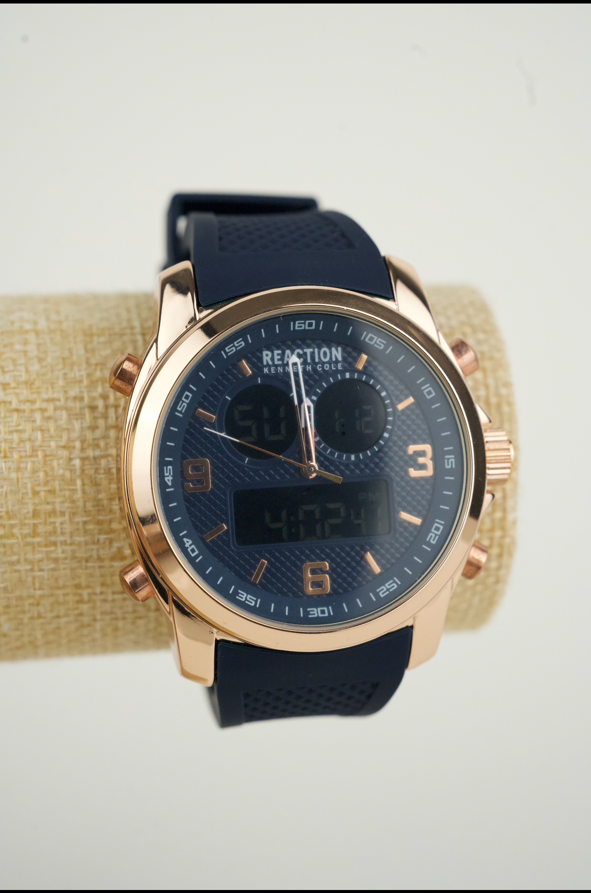 Kenneth Cole Reaction men's analog-digital watch with a rose gold-tone case and a blue silicone strap.