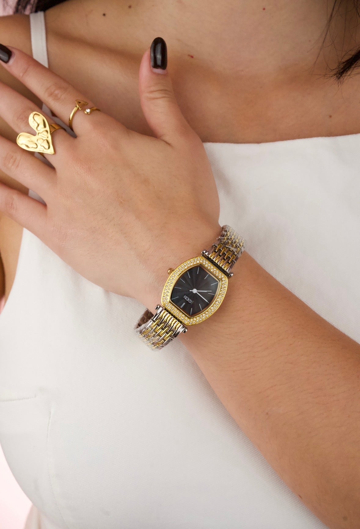 This is a GEDI women's two-tone wristwatch with a black analog dial and crystal-accented bezel