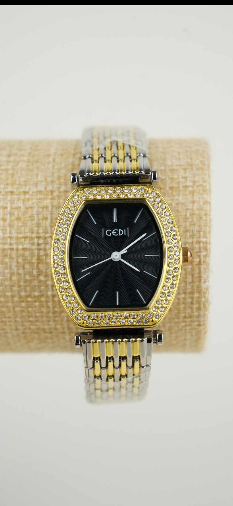 This is a GEDI women's two-tone wristwatch with a black analog dial and crystal-accented bezel