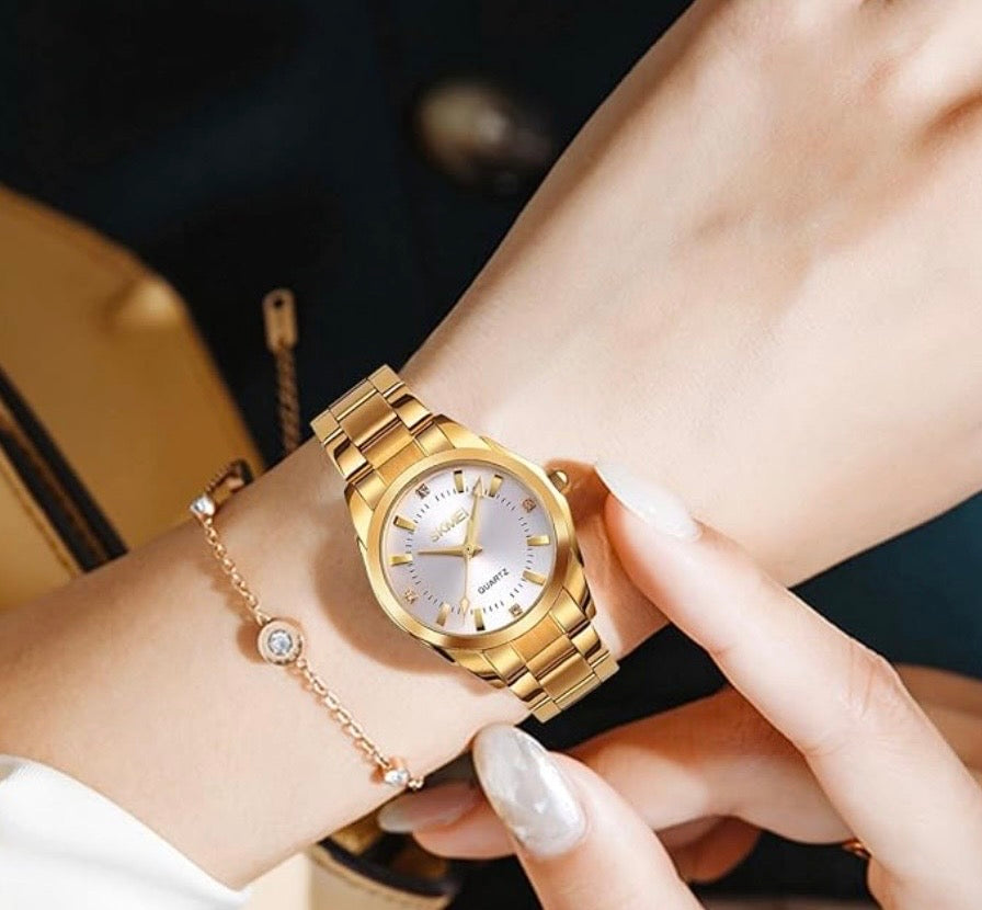 This is a gold-tone SKMEI 1620 luxury quartz women's watch with a stainless steel band and a white dial.